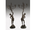 Pair of bronze torchiere holding 3-arm chandeliers figure statues with marble base 