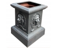 Cast iron plinth base with lionhead figures relief