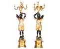 Pair of faux gilt bronze resin blackamoor torchierers sculptures holding candelabra