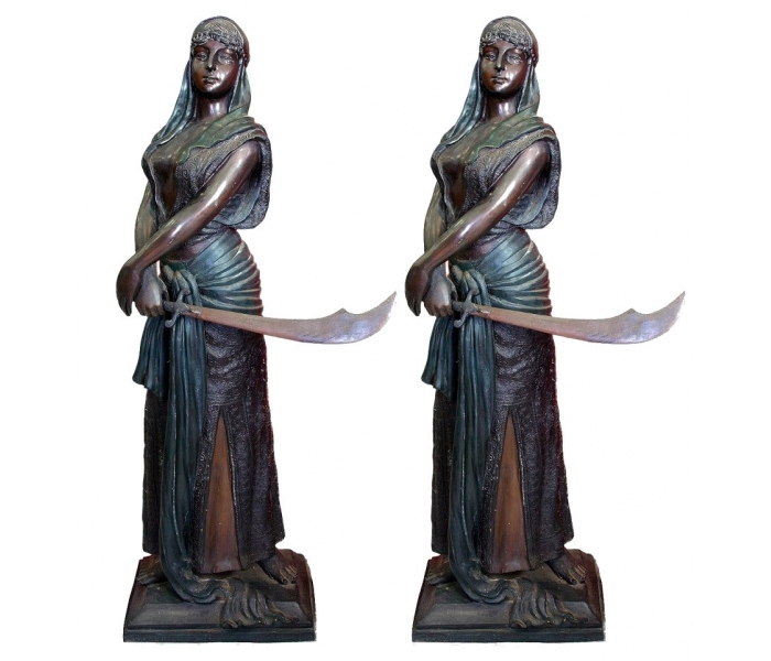 Pair of bronze Arab women with swords...