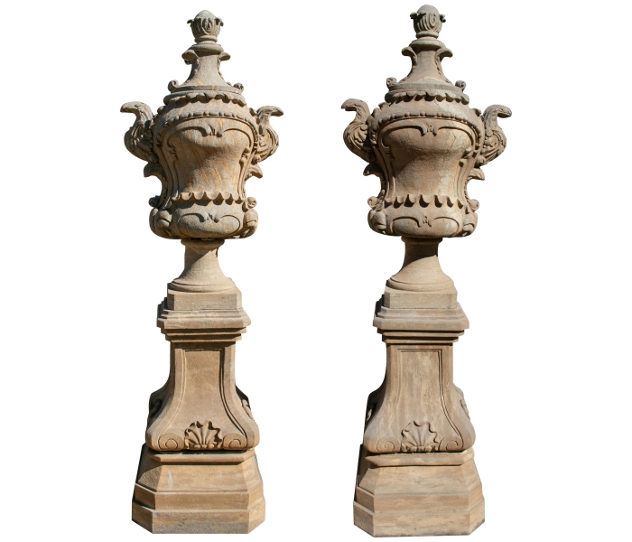 Pair of Rococo stone urns with bases...