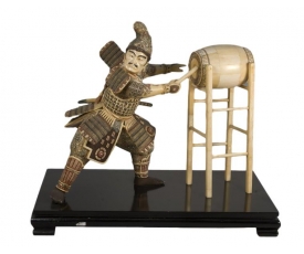 Oriental carved bone Japanese warrior playing drums statue with wooden plinth