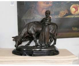 Figure of a peasant woman touching a cow in bronze and marble