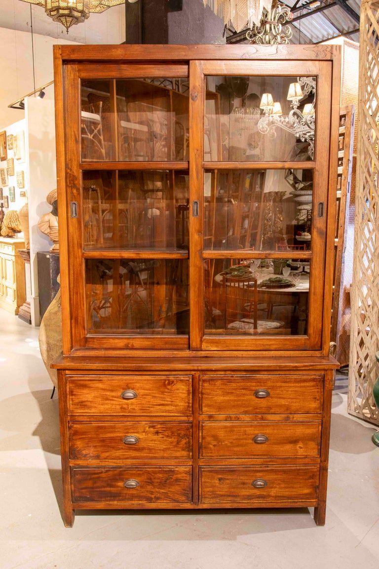 Vitrina antigua de madera de los años 50 con puertas correderas y seis cajones